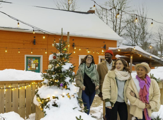 Group of people walking through Christmas themed decorations